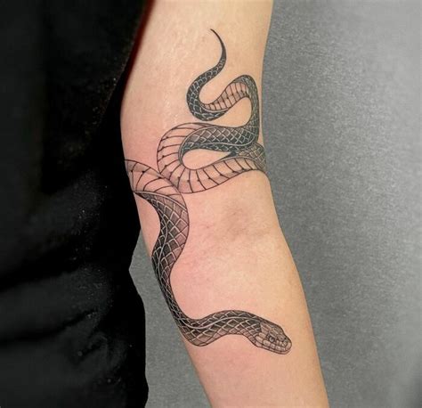 wrap around snake tattoo arm|Snake wrapping around arm tattoo